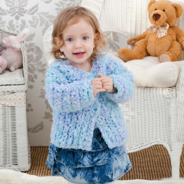 A little girl holding a teddy bear