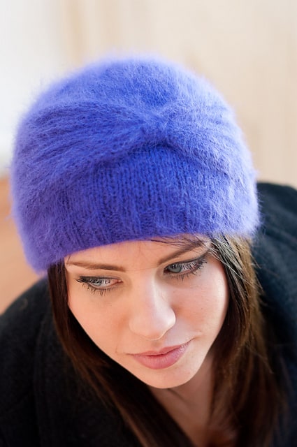 A close up of a person wearing a hat