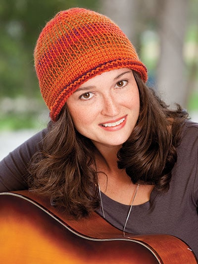 A close up of a woman wearing a hat - Kim Guzman