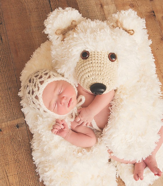 A close up of a stuffed animal and baby